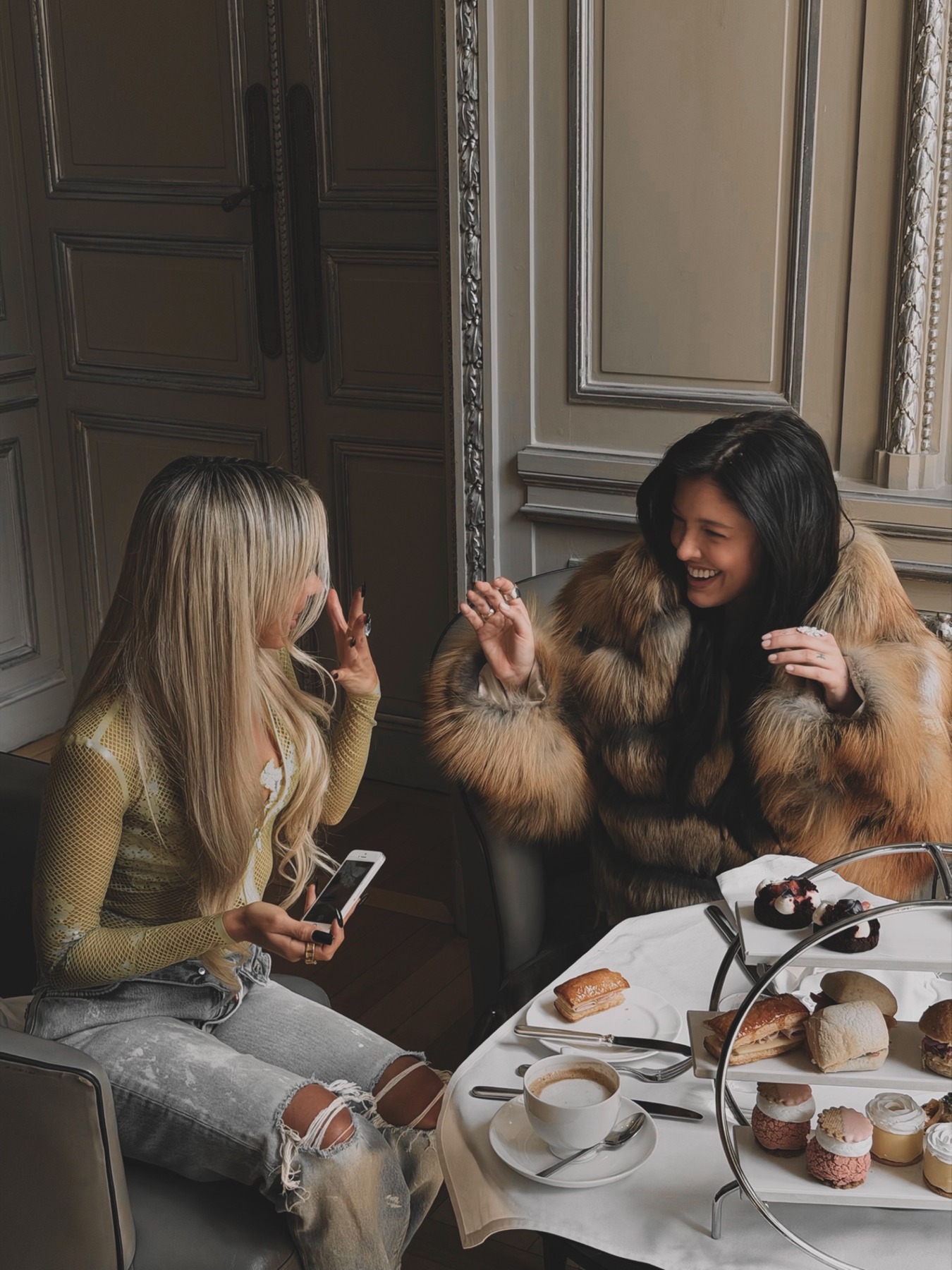 Bad Gyal and Sofía Gonet laughing over afternoon tea