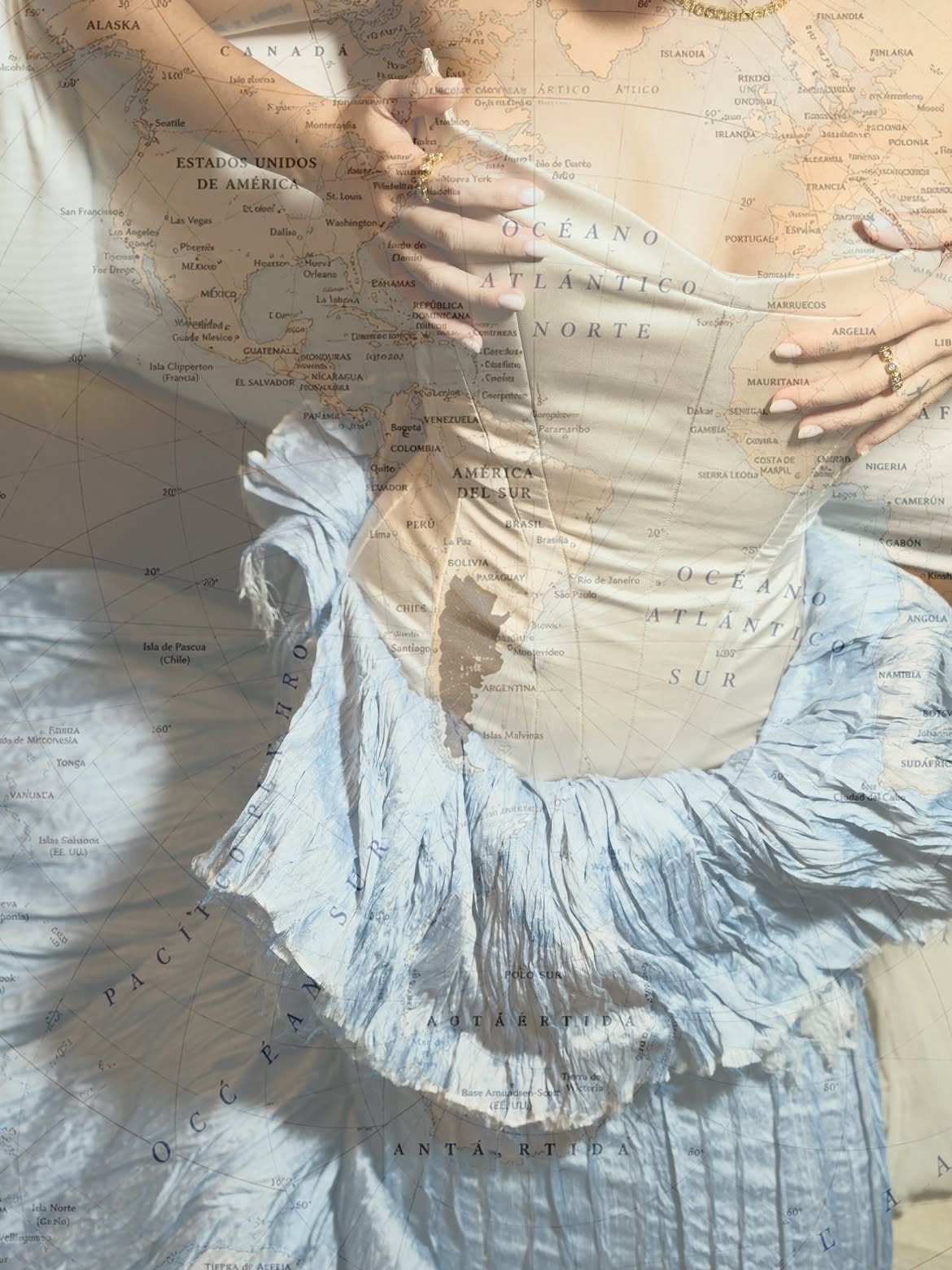 The corset gown with a world map layered over it