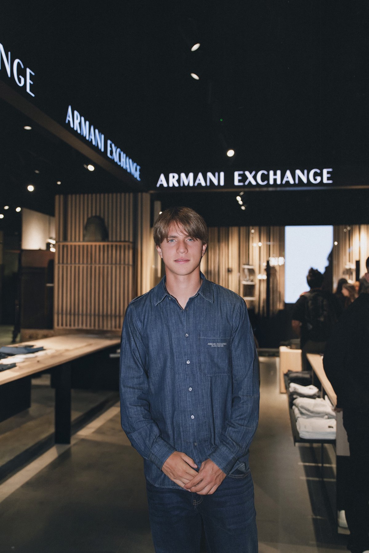 Valentino in an Armani Exchange denim shirt inside the store